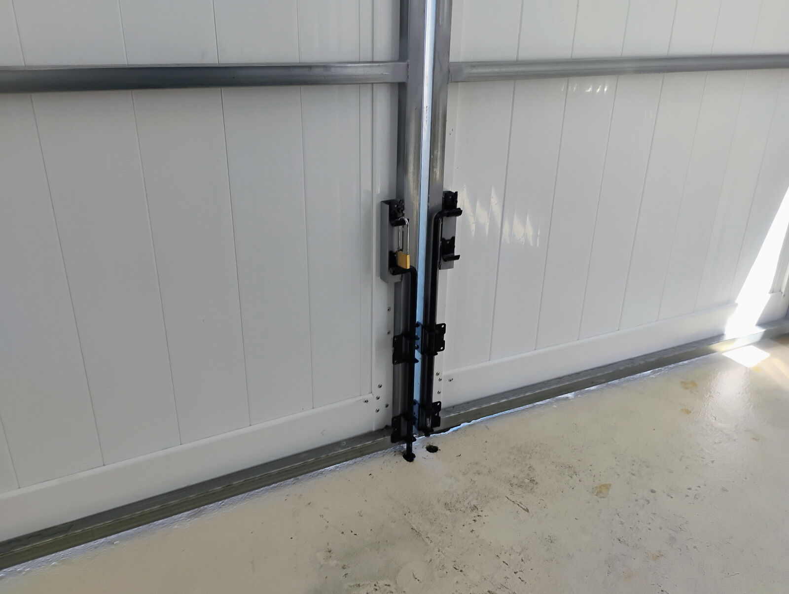 Steel frame vinyl gate drop rod and padlock hardware detail in Hernando Beach FL