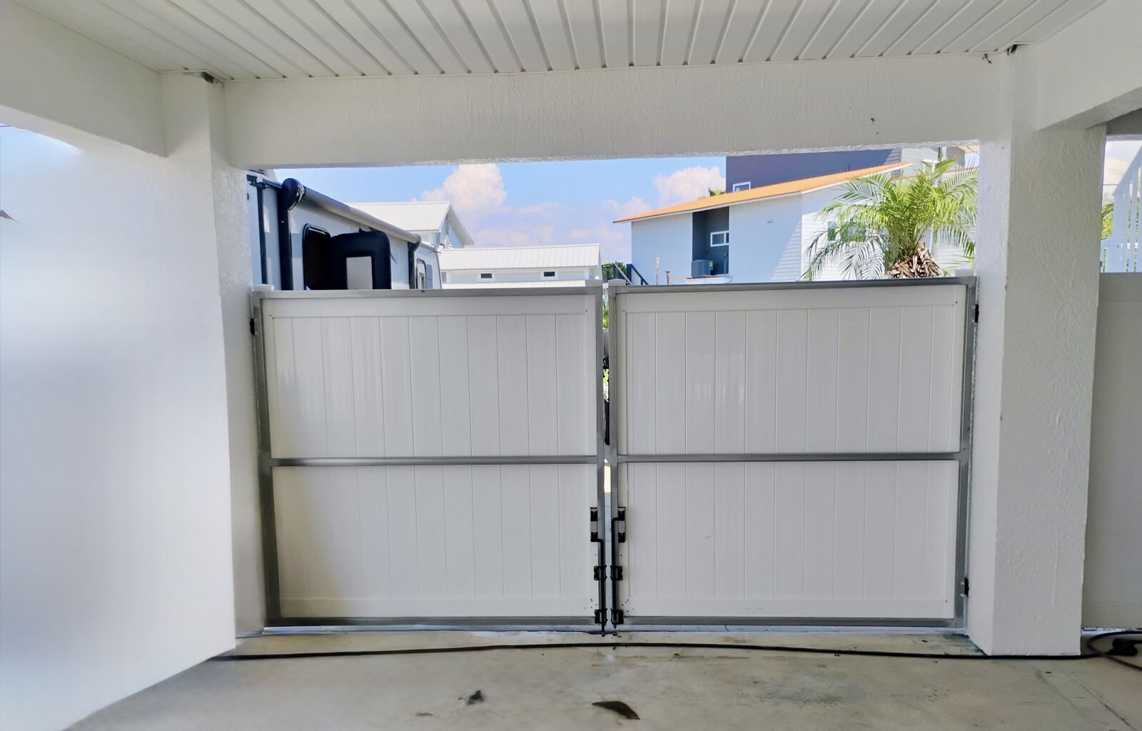 Custom steel frame white vinyl double gate for carport in Hernando Beach FL