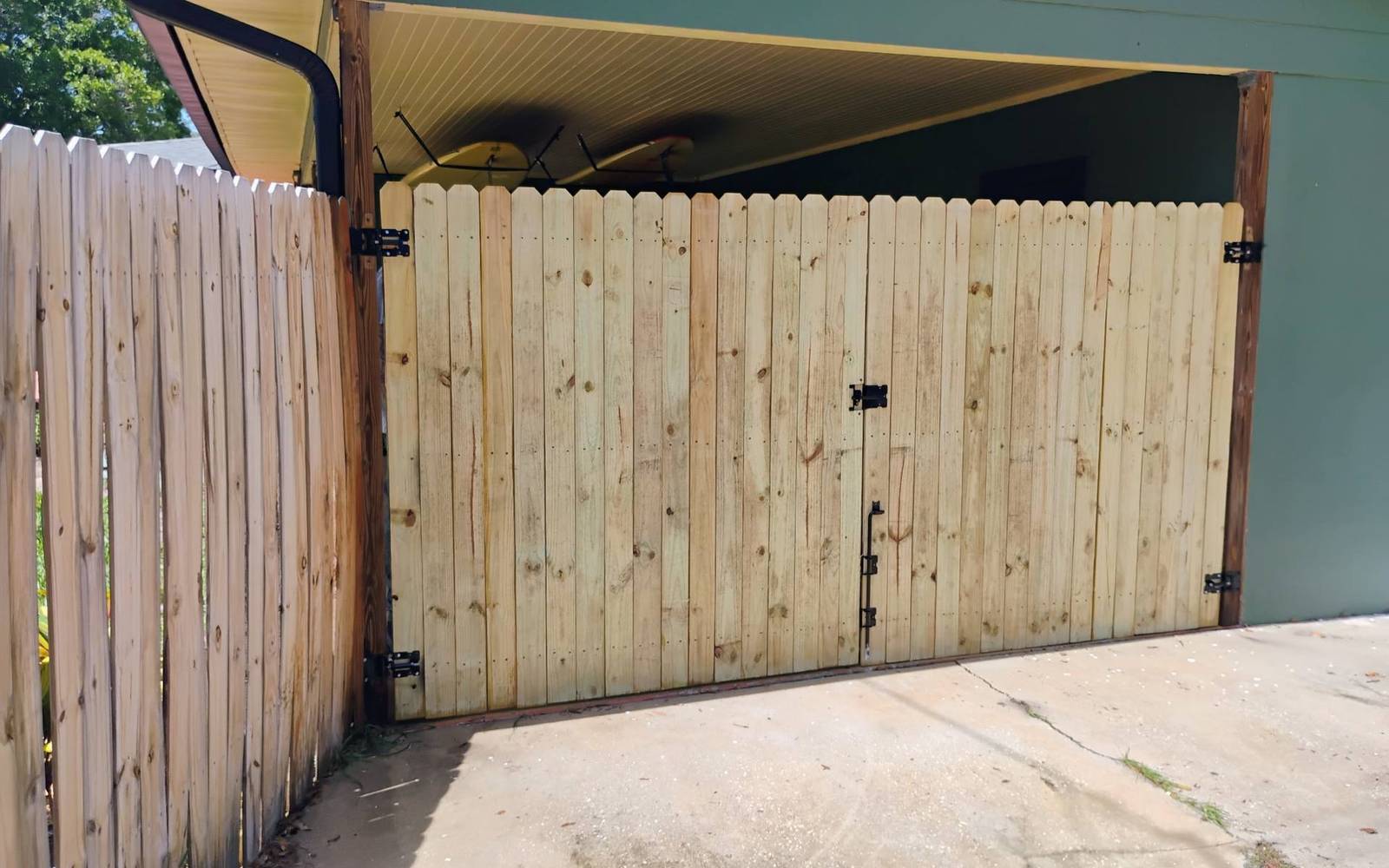 Wood double drive gate at a carport in Hernando County FL
