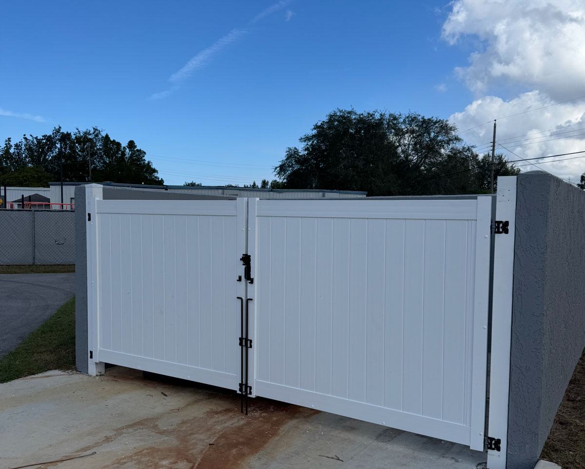 Double swing gate detail on a vinyl dumpster enclosure