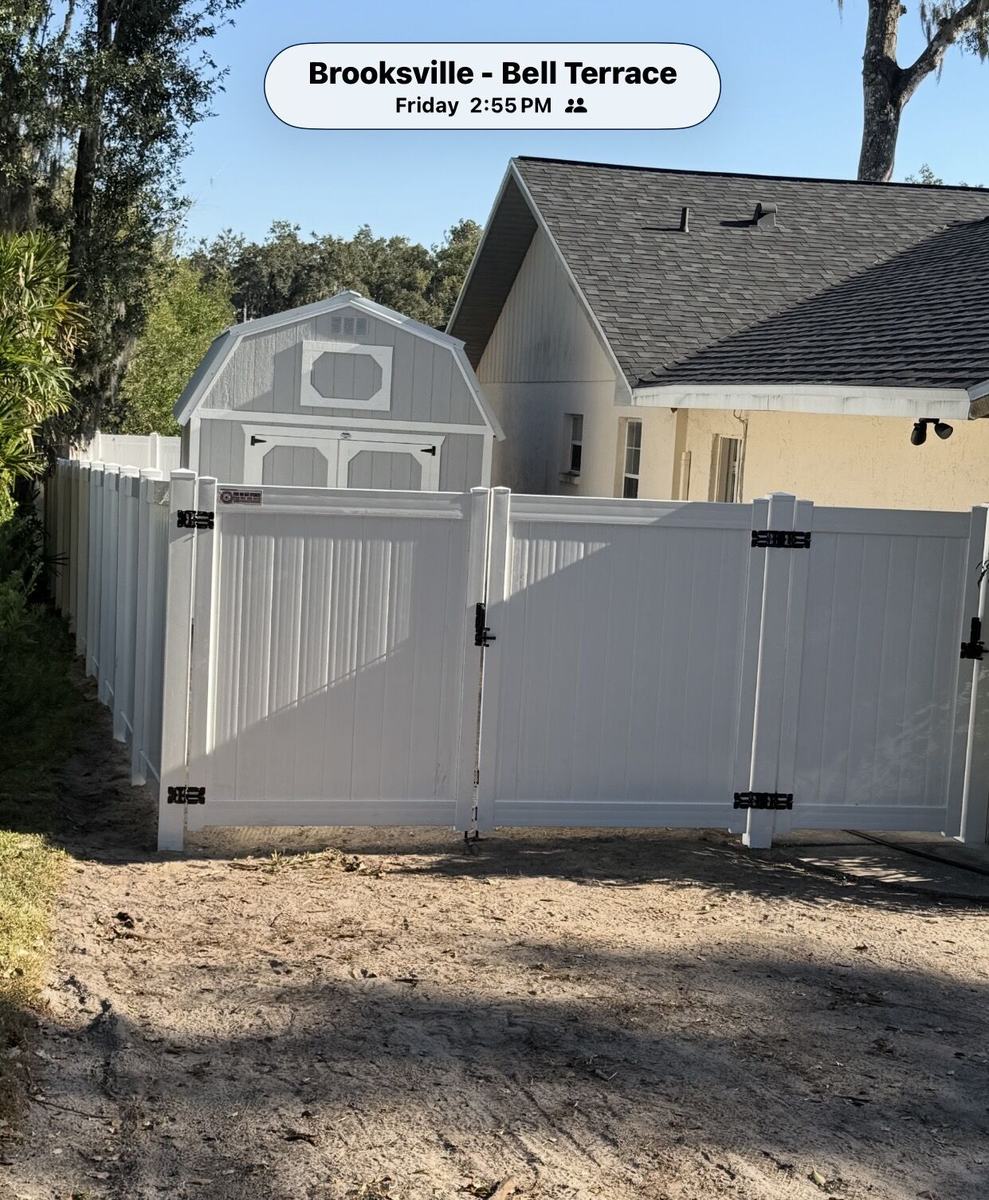 White vinyl privacy fence with a double gate in Brooksville, FL