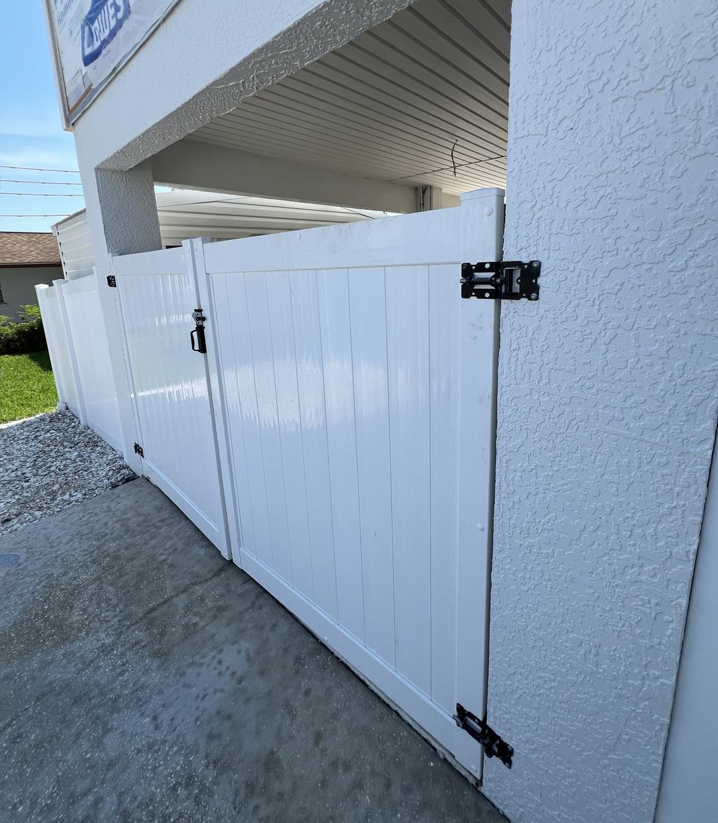 White vinyl walk gate and double gate on a Hernando Beach home