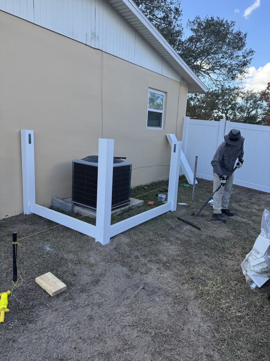 Installing a white vinyl AC unit enclosure in Hernando County, FL