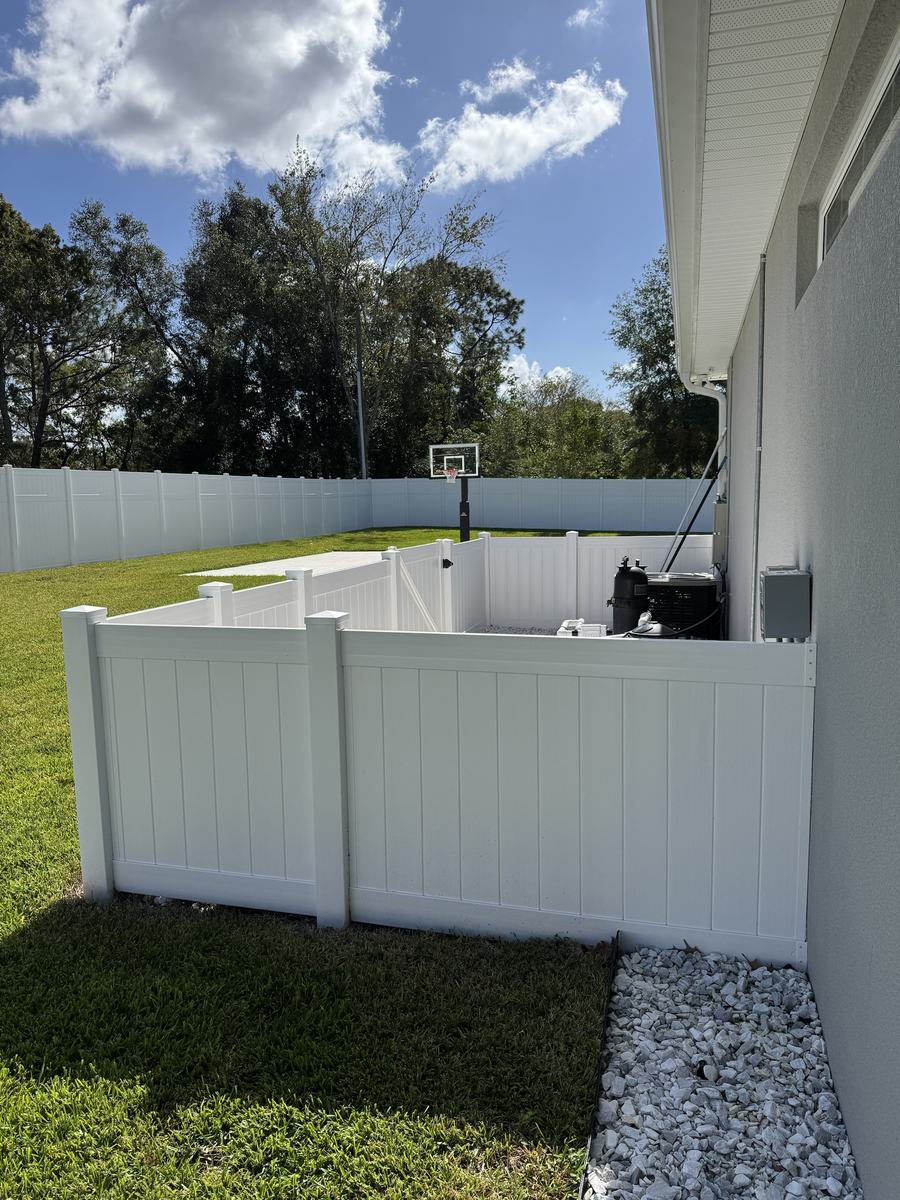 White vinyl pool equipment enclosure with a gate in Hernando County, FL