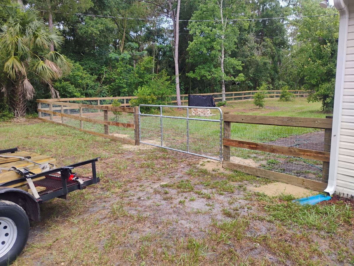 Yard gate on a 3-board ranch rail fence in Homosassa, FL