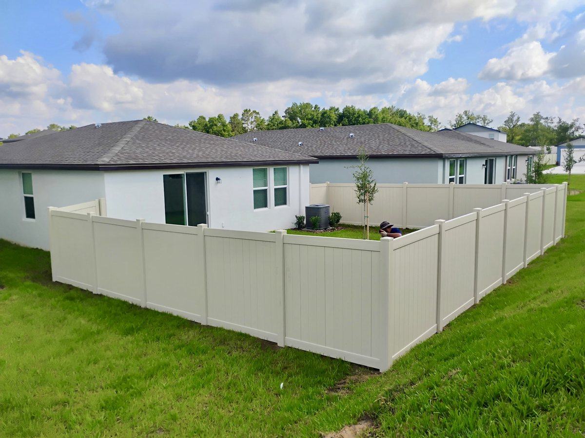 Tan vinyl privacy fence backyard view in Spring Hill, FL