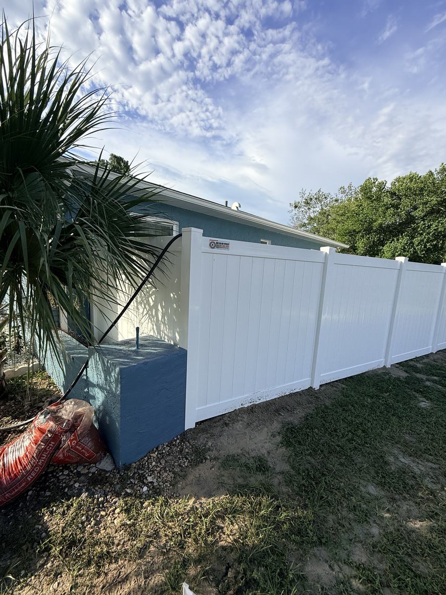 Corner of a white vinyl privacy fence at a home in Spring Hill, FL