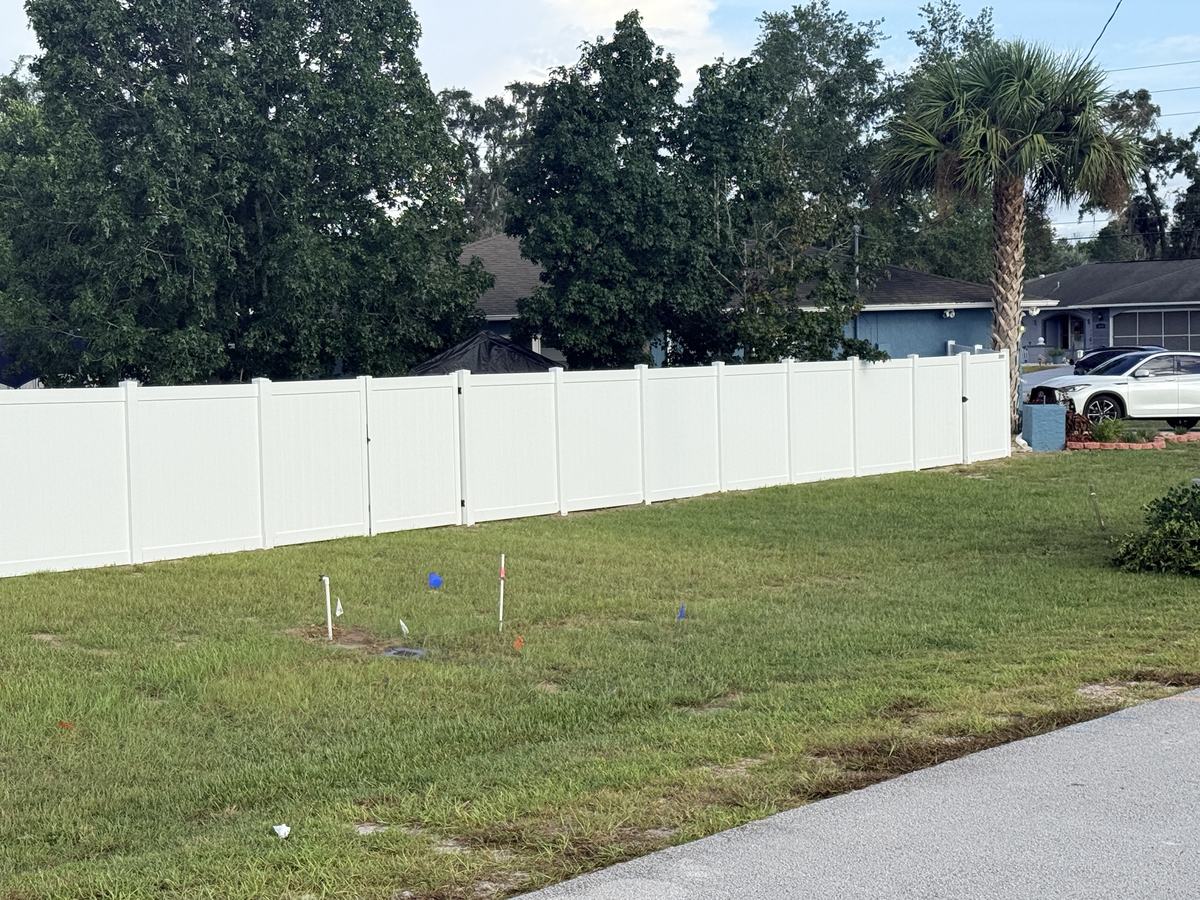 White vinyl privacy fence with walk gates in Spring Hill, FL
