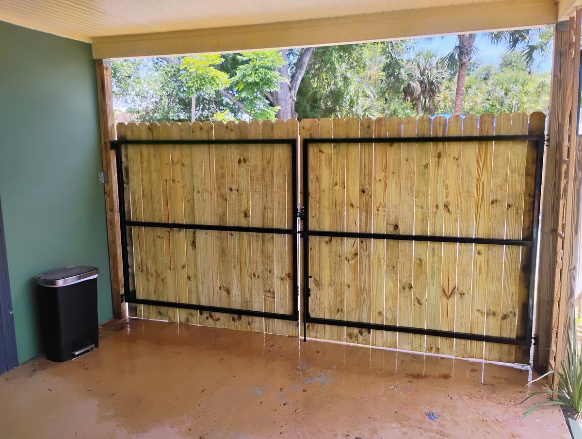 Black steel frames behind new wood gate pickets in St. Petersburg, FL