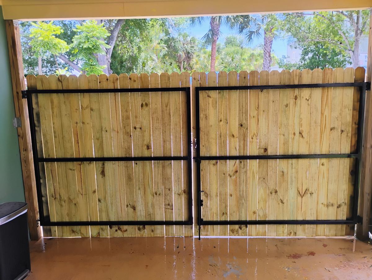 Custom steel-frame wood double gates in a St. Petersburg, FL carport