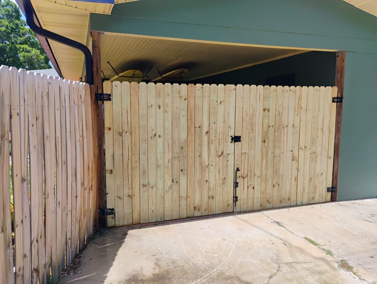 Outside view of new wood privacy double gates in St. Petersburg, FL