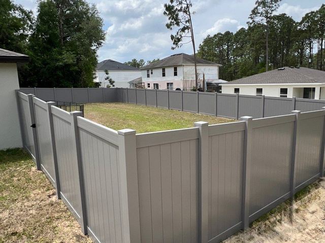 Gray vinyl privacy fence around a backyard in Spring Hill, FL