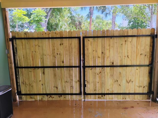 Custom steel-frame wood double gates in a St. Petersburg, FL carport