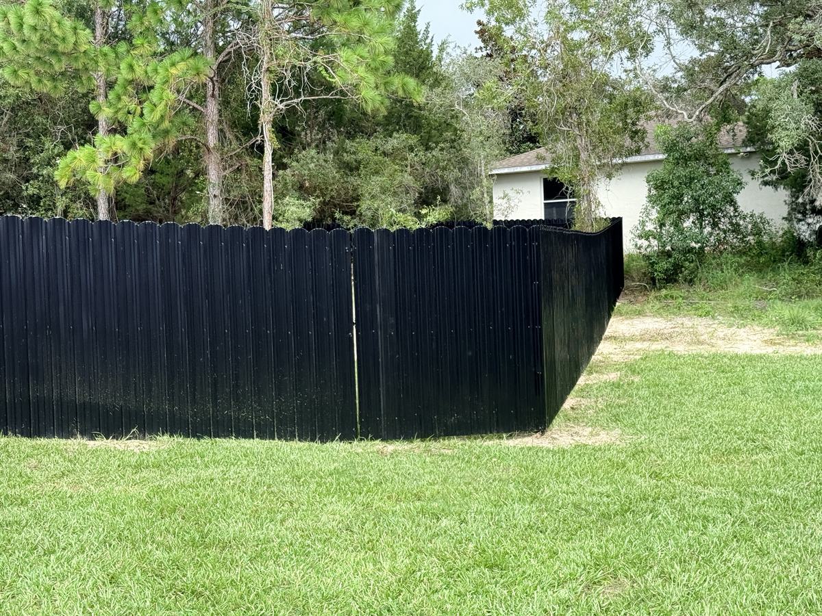 Black Dura Fence double gate in a Weeki Wachee backyard